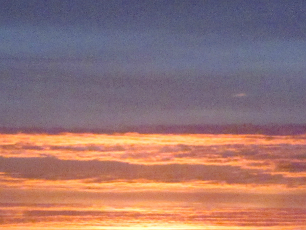 Rising sun illuminates clouds