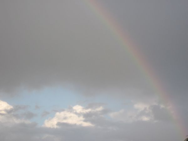 Clouds breaking with rainbow