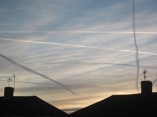 aircraft trails in the morning sky
